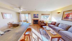 a living room with a couch and a table at Kokopelli's Kiva #3230 in Moab