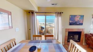a dining room with a table and a fireplace at Kokopelli's Kiva #3230 in Moab