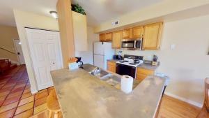 a kitchen with a sink and a stove top oven at Kokopelli's Kiva #3230 in Moab +29 photos