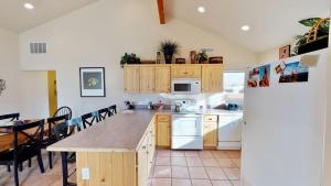 a kitchen with white appliances and a table with chairs at Jan's Joy #N3 in Moab