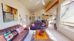 a living room with a leather couch and a table at Jan's Joy #N3 in Moab