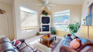 a living room with a leather couch and a table at Jan's Joy #N3 in Moab +27 photos