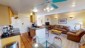 a kitchen and living room with a couch and a table at Kokopelli Dream #3251 in Moab