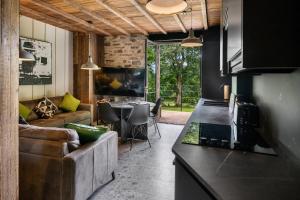 a kitchen and living room with a couch and a table at The Stables in Bearney