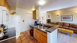 a kitchen with a sink and a couch in a room at Kokopelli Dream #3251 in Moab