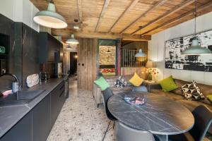 a kitchen and living room with a table and a couch at The Stables in Bearney