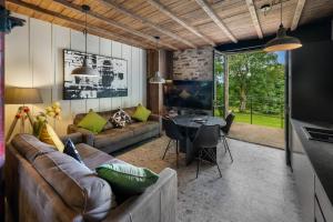a living room with a couch and a table at The Stables in Bearney