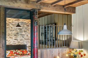 a room with a stone wall and two pendant lights at The Stables in Bearney +24 photos