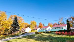 a row of houses on a road with trees at Skyline Cabins in Ingonish