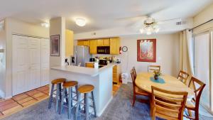 a kitchen and dining room with a table and chairs at River Days #3326 in Moab