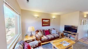 a living room with a couch and a tv at River Days #3326 in Moab