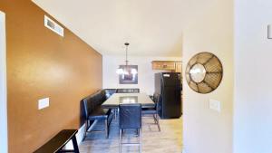 a dining room with a table and chairs and a refrigerator at Red Cliff Condos #1B in Moab
