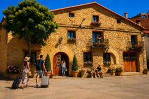 a group of people standing outside of a building at Casa Rural Julio in Terriente