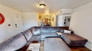 a living room with a large brown leather couch at Red Cliff Condos #1H in Moab