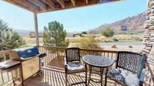 a patio with a table and two chairs and a grill at Red Cliff Condos #1H in Moab +26 photos