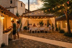 a group of people sitting at a table in a courtyard at Casa Rural Julio in Terriente