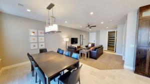 a dining room and living room with a table and chairs at Entrada at Moab #628 in Moab