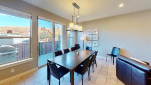 a dining room with a table and chairs and a large window at Entrada at Moab #628 in Moab