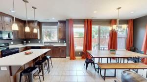 a kitchen with two tables and chairs in it at Entrada at Moab #430 in Moab +52 photos