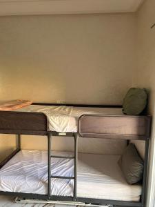 a room with two bunk beds in it at Sable d or saidia in Saïdia