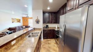 a large kitchen with a stainless steel refrigerator at Slick Rock Reserve #12A3 in Moab