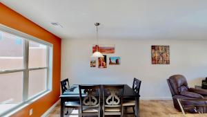 a dining room with a table and chairs and a window at Slick Rock Reserve #12A3 in Moab