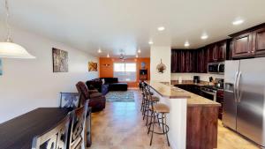 a kitchen and living room with a stainless steel refrigerator at Slick Rock Reserve #12A3 in Moab +32 photos