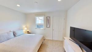 a bedroom with a bed and a flat screen tv at Slot Canyon #B in Moab