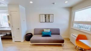 a living room with a couch with a blue pillow at Slot Canyon #C in Moab