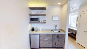 a small kitchen with a sink and a microwave at Slot Canyon #C in Moab