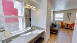 a bathroom with a sink and a window and a chair at Slot Canyon #C in Moab