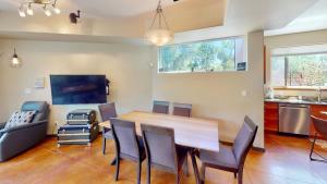 a dining room with a wooden table and chairs at Millcreek on Main in Moab