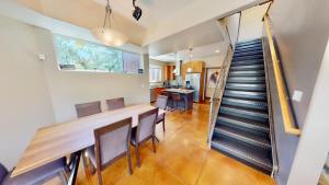 a dining room with a table and chairs and a staircase at Millcreek on Main in Moab +42 photos