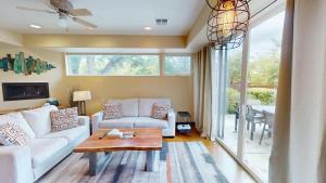 a living room with a white couch and a table at Millcreek on Main in Moab