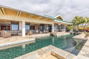 an exterior view of a house with a swimming pool at Waterfall House - Hawaii in Kailua-Kona +38 photos