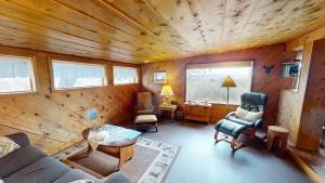 a living room with a couch and chairs in a cabin at Pack Creek ~ Trails End in Spanish Valley