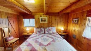 a bedroom with a bed in a wooden cabin at Pack Creek ~ Trails End in Spanish Valley +29 photos