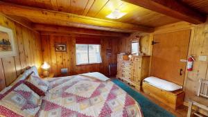 a bedroom with a bed in a wooden cabin at Pack Creek ~ Trails End in Spanish Valley