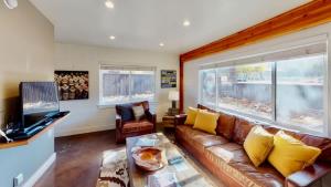 a living room with a couch and a television at Moab Flats #4 in Moab