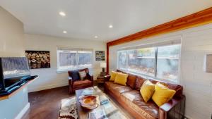 a living room with a couch and a tv at Moab Flats #4 in Moab