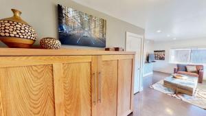 a living room with a large wooden cabinet with vases on it at Moab Flats #4 in Moab