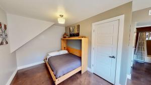 a small bedroom with a bed and a white door at Moab Flats #4 in Moab