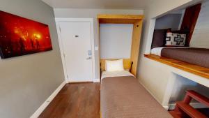 a small room with a bed and a small room with a shelf at Moab Flats #5 in Moab