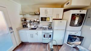 a small kitchen with white appliances and a washer and dryer at Moab Flats #5 in Moab +26 photos