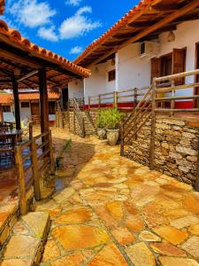 a stone patio in front of a house at Pousada Recanto da Serrinha in Corumbá de Goiás