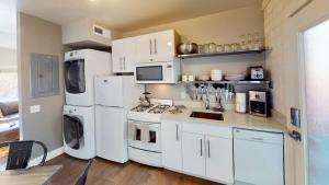 a kitchen with white appliances and white cabinets at Moab Flats #6 in Moab