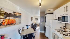 a kitchen with a white refrigerator and a table in it at Moab Flats #6 in Moab