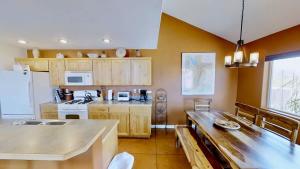 a kitchen with wooden cabinets and a counter top at Saddle Creek #3A1 in Moab