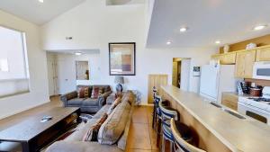 a kitchen and living room with a couch and a table at Saddle Creek #3A1 in Moab +28 photos