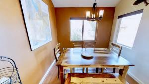 a dining room with a wooden table and chairs at Saddle Creek #3A1 in Moab